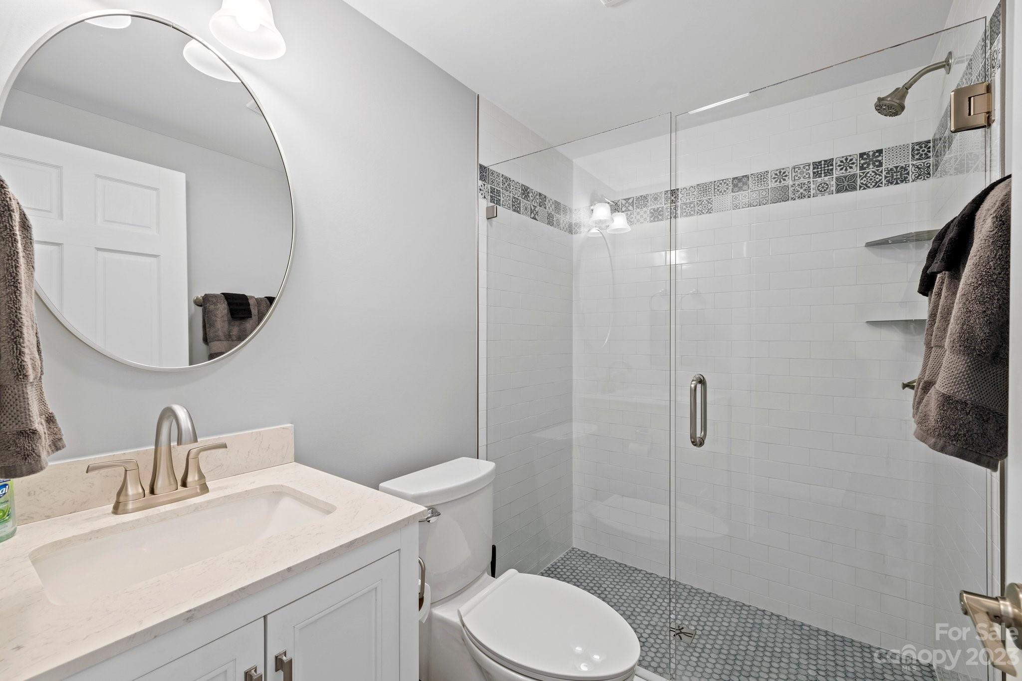 188 White Oak Gap Road Asheville, NC 28803 - Photo 45 of 48 a bathroom with a sink toilet vanity and shower