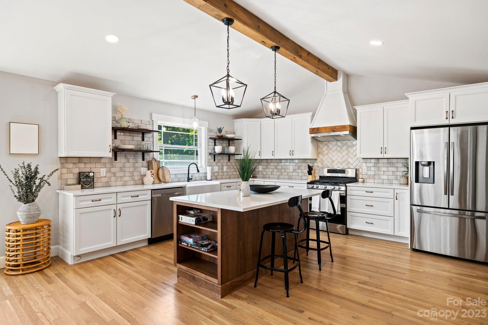 188 White Oak Gap Road Asheville, NC 28803 - Photo 6 of 48 a kitchen with white cabinets stainless steel appliances and wooden floor