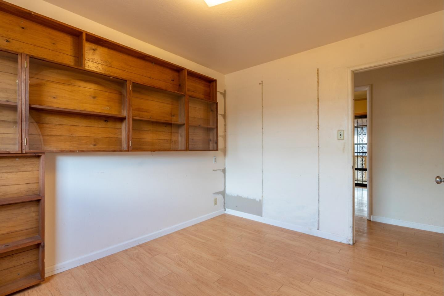 1139 Peralta Road Pacifica, CA 94044 - Photo 14 of 23 a view of an empty room with wooden floor and a window