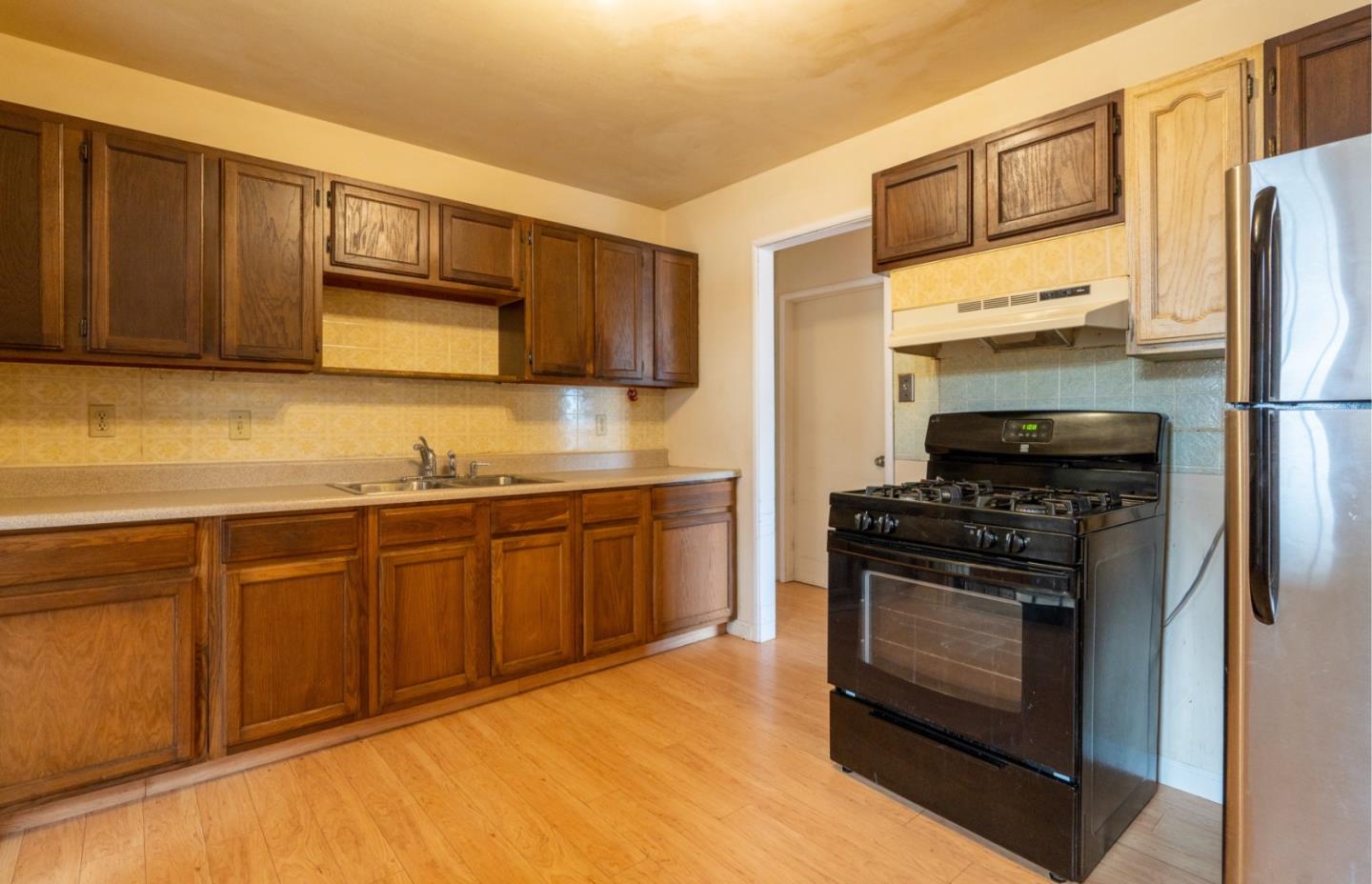 1139 Peralta Road Pacifica, CA 94044 - Photo 5 of 23 a kitchen with stainless steel appliances granite countertop a stove a sink dishwasher a refrigerator and a microwave oven