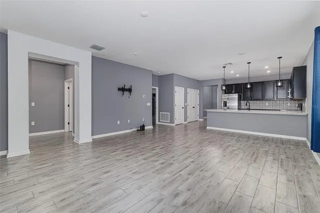 a view of a kitchen with wooden floor and a sink