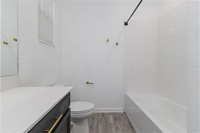 a bathroom with a sink a toilet and bathtub