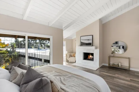 a bedroom with a bed and a fireplace