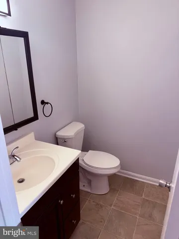 a white toilet sitting next to a bathroom sink