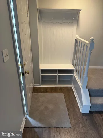 a view of staircase with white walls and railing