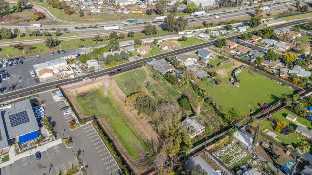 an aerial view of residential houses with outdoor space and swimming pool