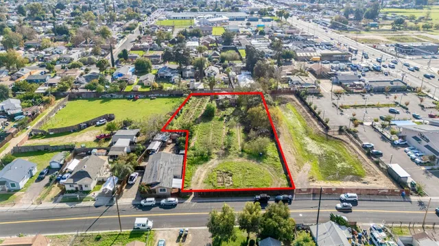 an aerial view of residential houses with outdoor space and swimming pool