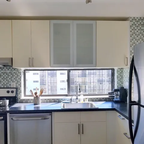 a kitchen with stainless steel appliances a sink and a window