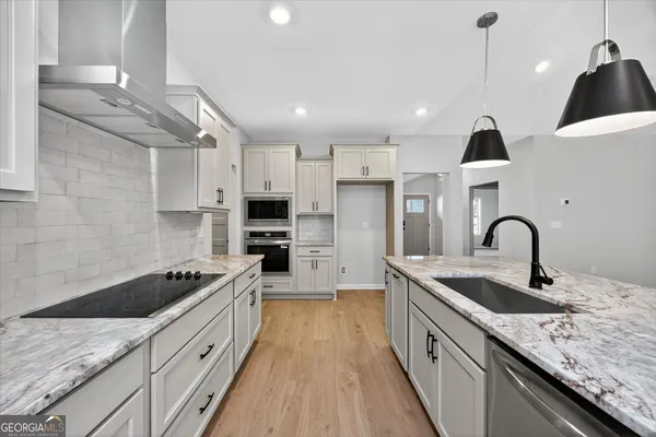 a kitchen with a stove and a sink