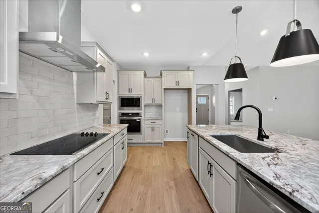 a kitchen with a stove and a sink