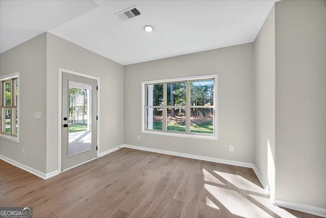 an empty room with closet and windows