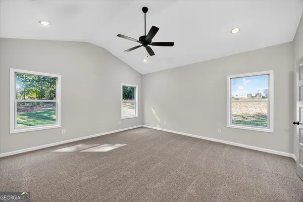 an empty room with closet and a ceiling fan