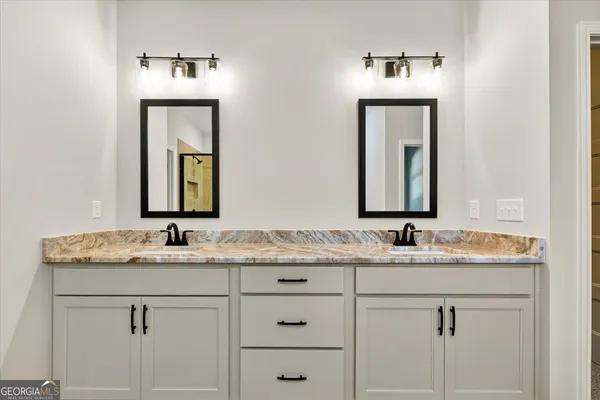 a bathroom with a tub sink and mirror