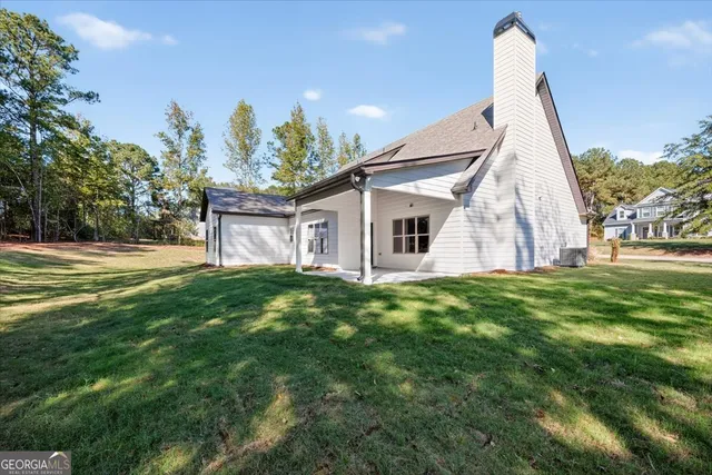a view of a backyard with large trees