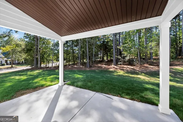 an aerial view of a house with a yard and a large pool
