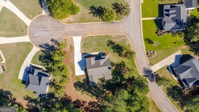 an aerial view of a house with swimming pool and sitting area