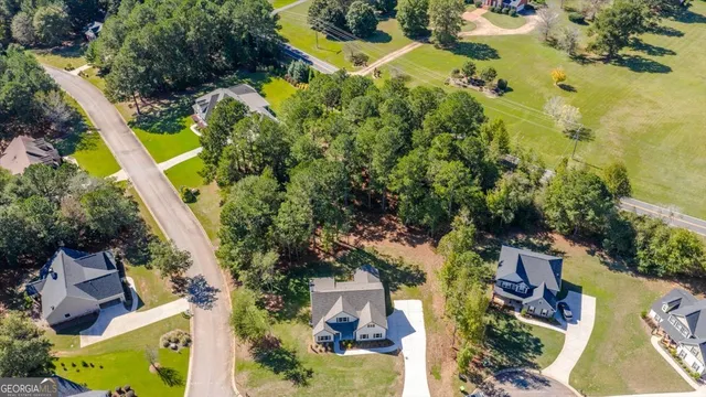 an aerial view of a house with a garden and swimming pool
