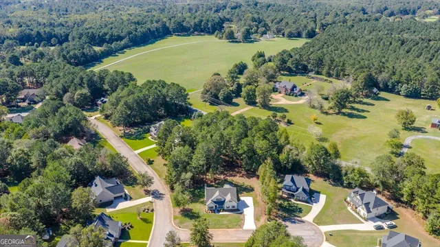 an aerial view of a house with a garden and yard