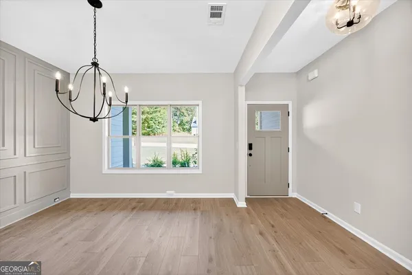 a view of a kitchen with a sink hardwood floor and a window