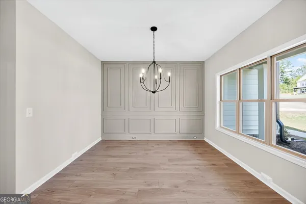 a view of an empty room with a window and fireplace
