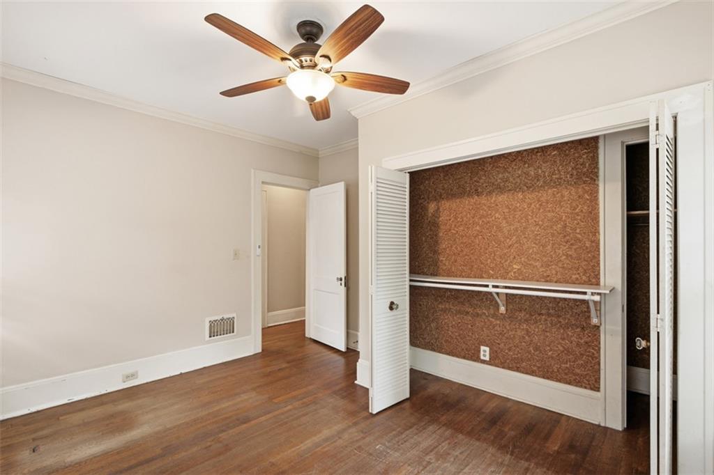 1424 Emory Road Northeast Atlanta, GA 30306 - Photo 22 of 36 an empty room with wooden floor and a ceiling fan