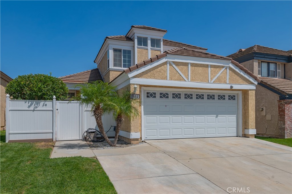 7651 Sandpiper Court Rancho Cucamonga, CA 91730 - Photo 1 of 1 a front view of a house with a yard and garage