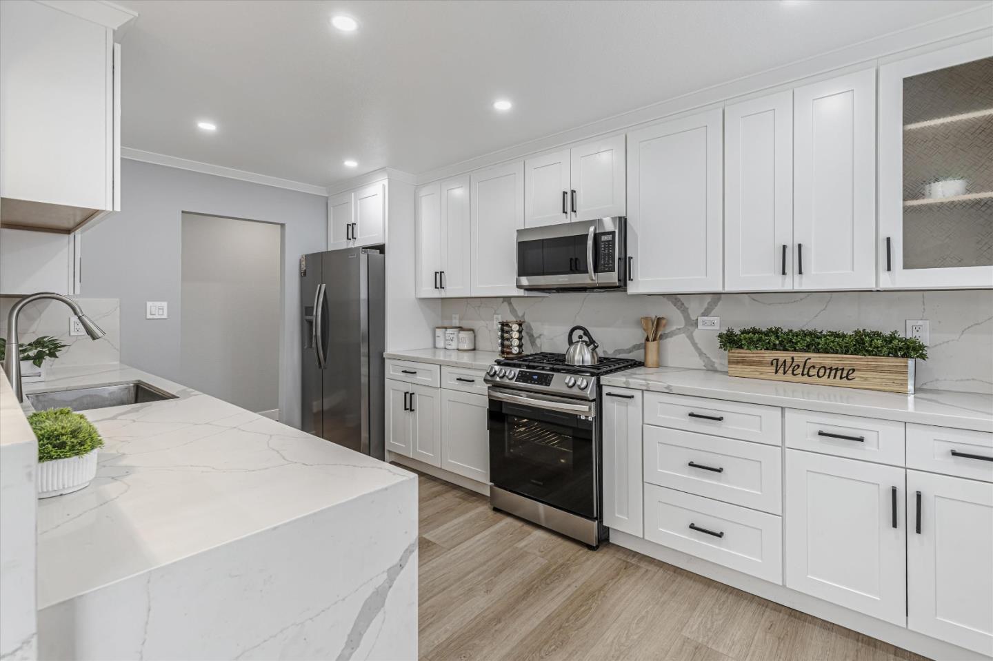 2797 Cornwall Drive San Jose, CA 95127 - Photo 6 of 24 a kitchen with stainless steel appliances a stove a sink a refrigerator white cabinets and a refrigerator