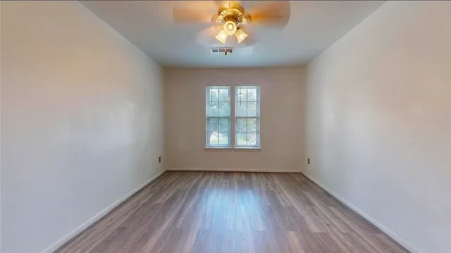 wooden floor in an empty room with a window