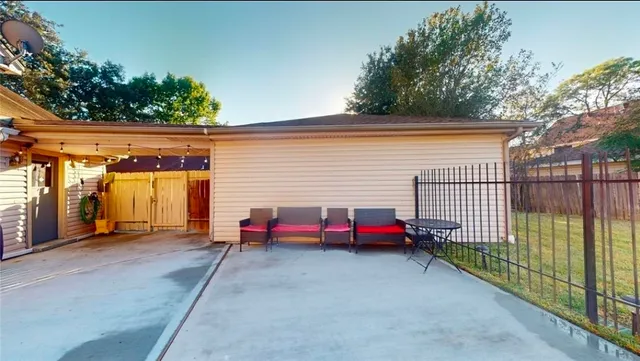 a view of a backyard with large trees and a barn