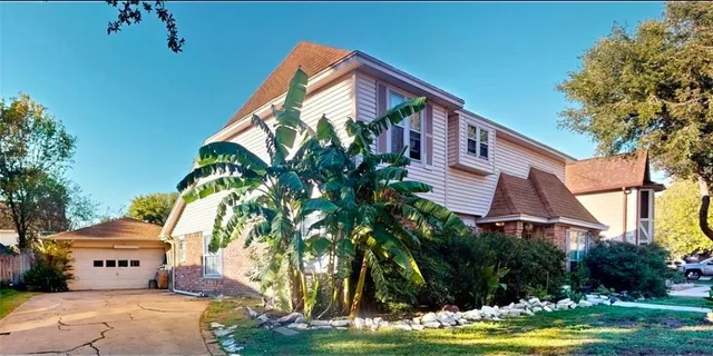 a front view of a house with garden