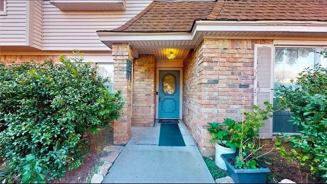 a view of entrance of the house with potted plants
