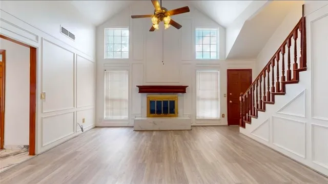 a view of an entryway with wooden floor and a fireplace