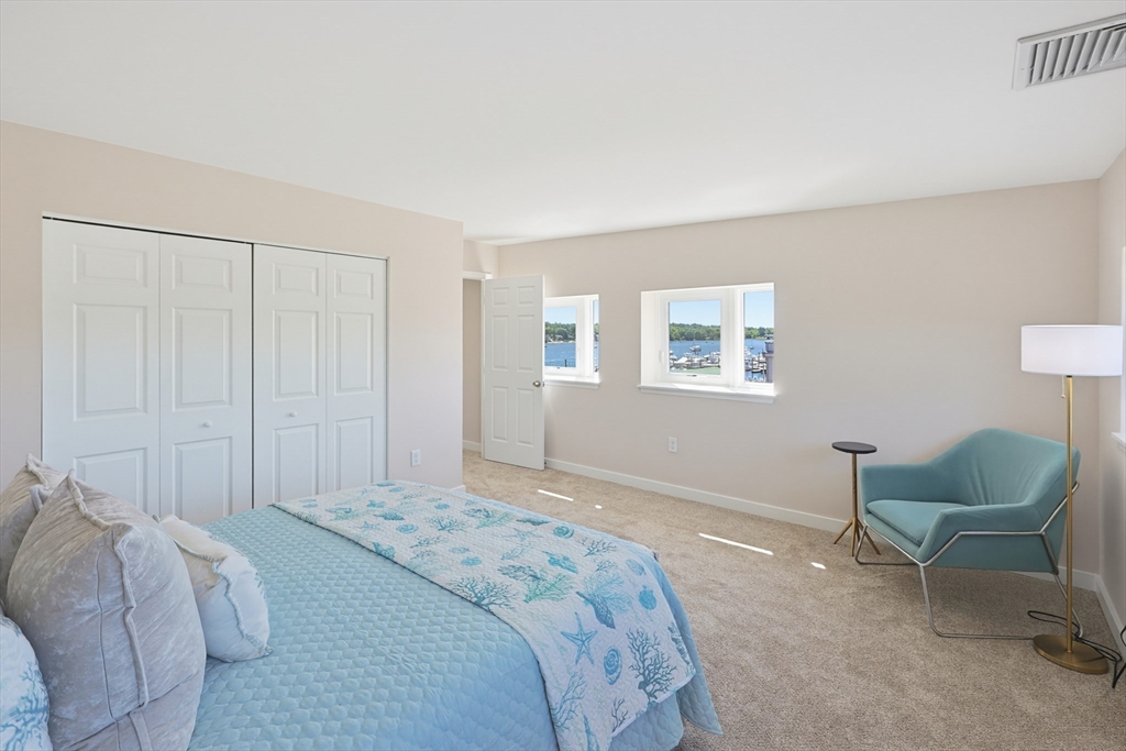 45 Main Street, Unit 35 Wareham, MA 02571 - Photo 16 of 34 a bedroom with a bed and a chair