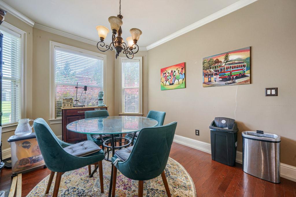 345 Masters Club Boulevard Hampton, GA 30228 - Photo 12 of 30 a view of a dining room with furniture and wooden floor