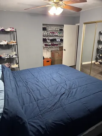a bedroom with a bed and wooden floor