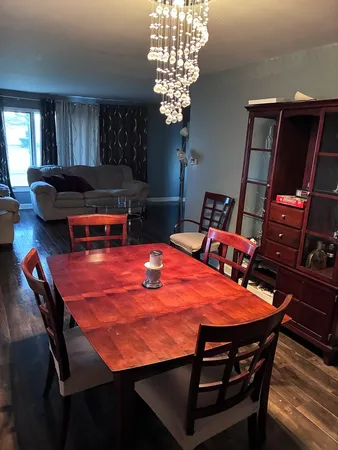 a dining room with furniture and wooden floor