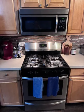 a stove top oven sitting inside of a kitchen