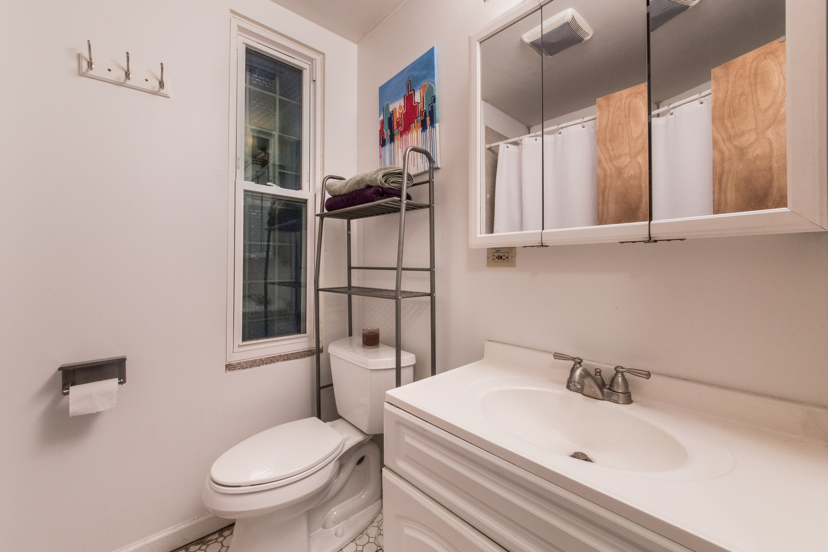 1249 North Cleaver Street, Unit G Chicago, IL 60642 - Photo 12 of 21 a white toilet sitting next to a bathroom sink