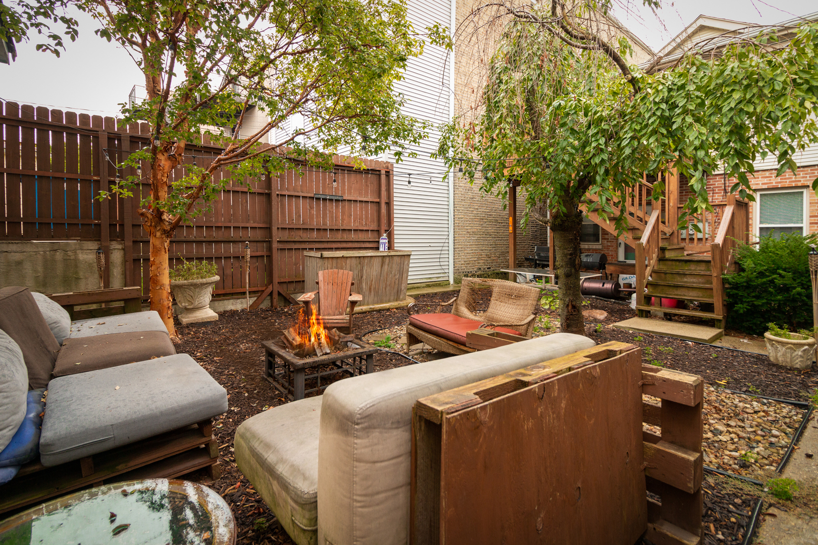 1249 North Cleaver Street, Unit G Chicago, IL 60642 - Photo 16 of 21 a view of a backyard with couches a large tree