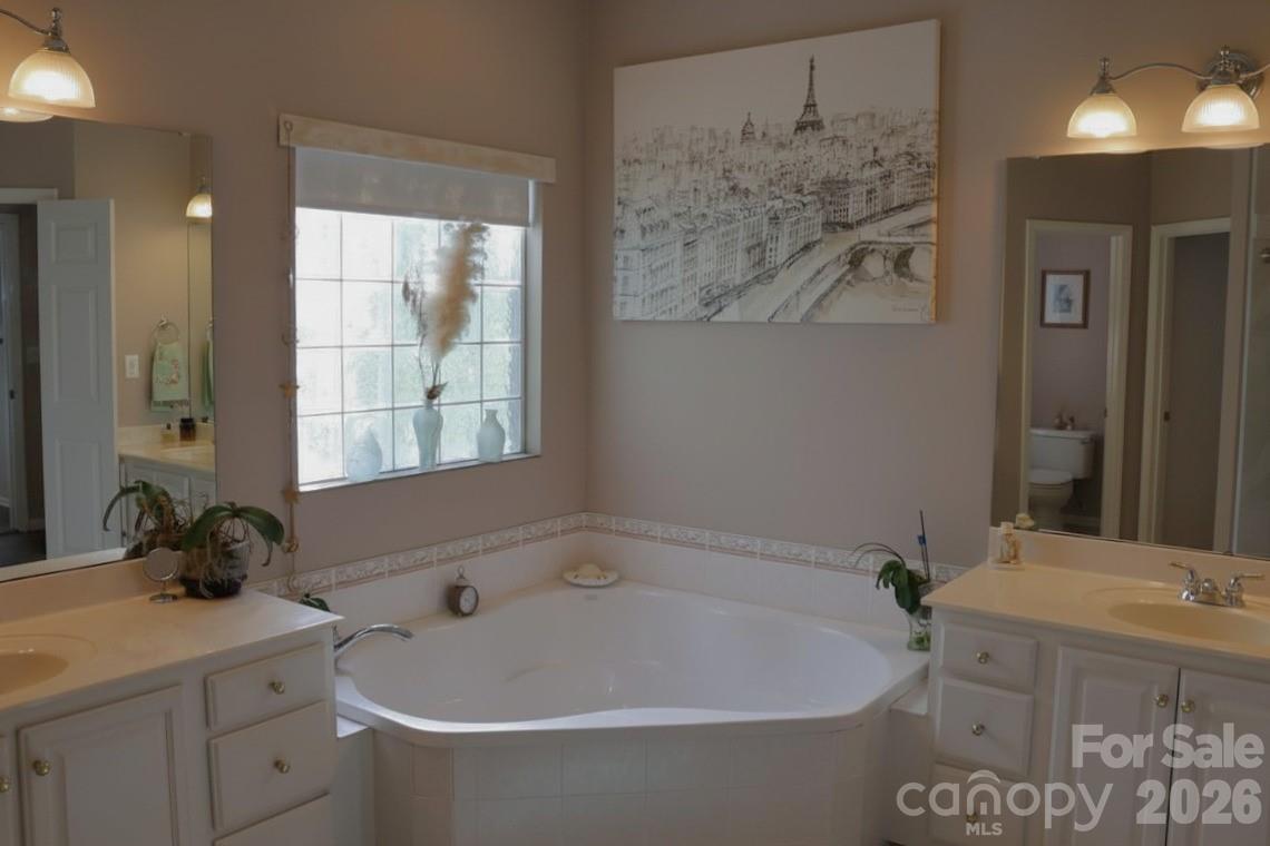 2325 Perry Road Denver, NC 28037 - Photo 12 of 28 a white bath tub sitting next to a bathroom sink