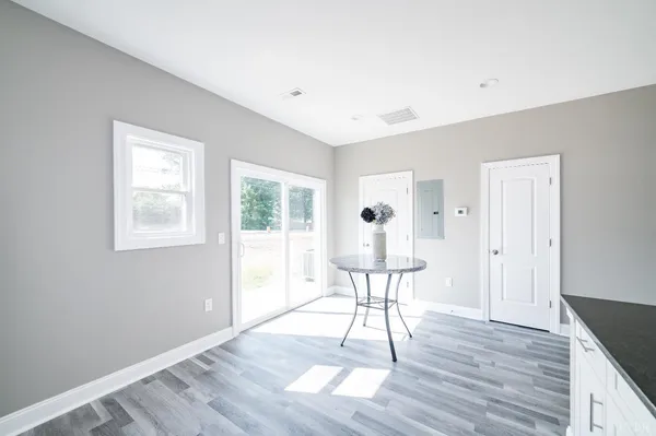 a view of a livingroom with wooden floor and a window