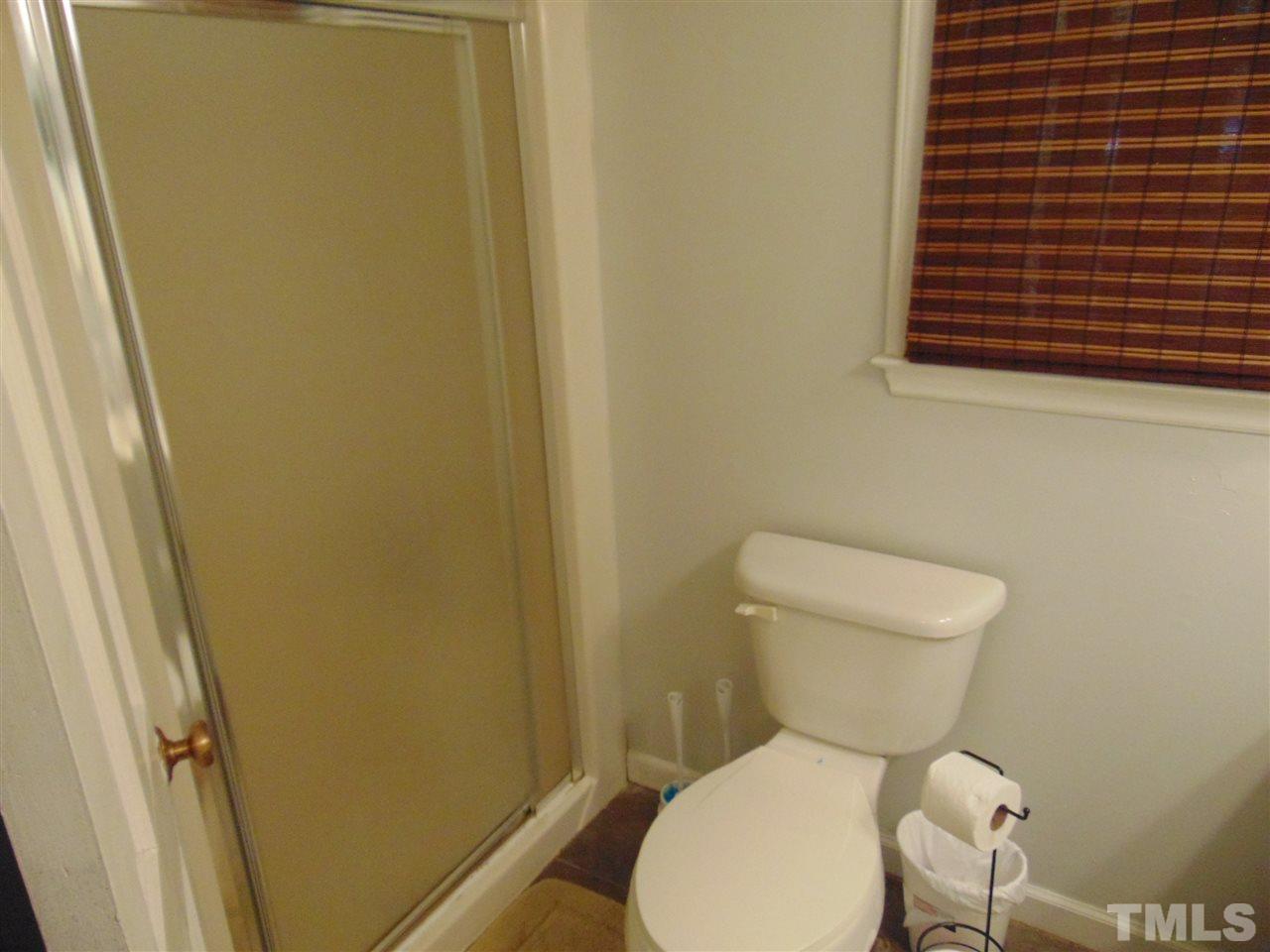 2068 Sanders Road Stem, NC 27581 - Photo 19 of 21 a white toilet sitting next to a small bathroom