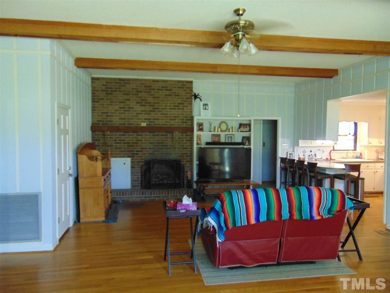 2068 Sanders Road Stem, NC 27581 - Photo 5 of 21 a living room with furniture and a fireplace