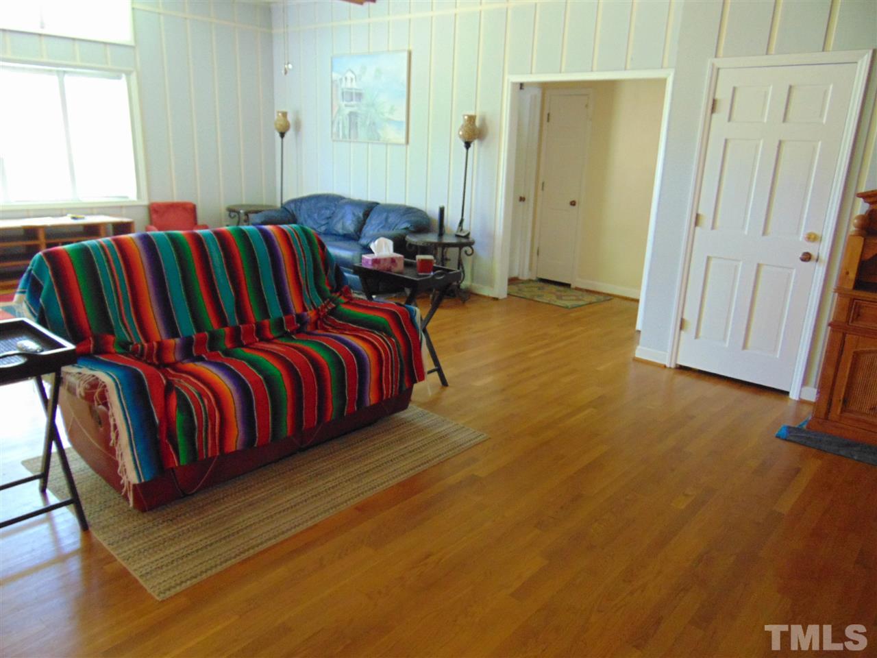 2068 Sanders Road Stem, NC 27581 - Photo 6 of 21 a view of walk in closet with rug and wooden floor