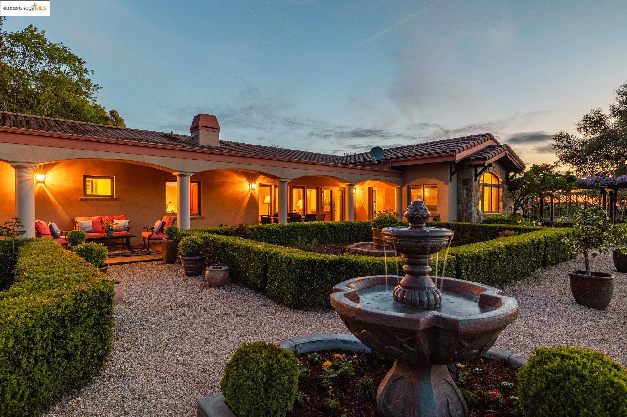 10270 Slate Rim Road Sonora, CA 95370 - Photo 1 of 55 Back of house featuring a tiled roof, a patio area, stucco siding, and an outdoor hangout area