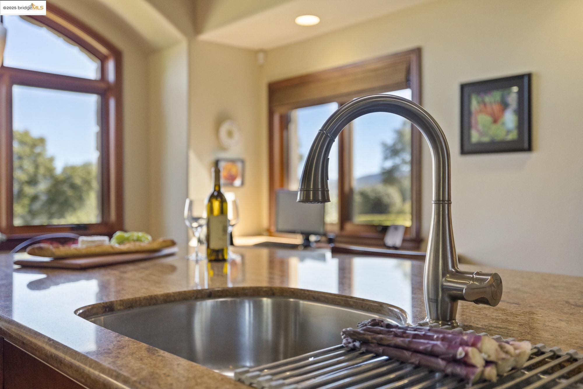 10270 Slate Rim Road Sonora, CA 95370 - Photo 21 of 55 a kitchen with a sink and a dining table with garden view