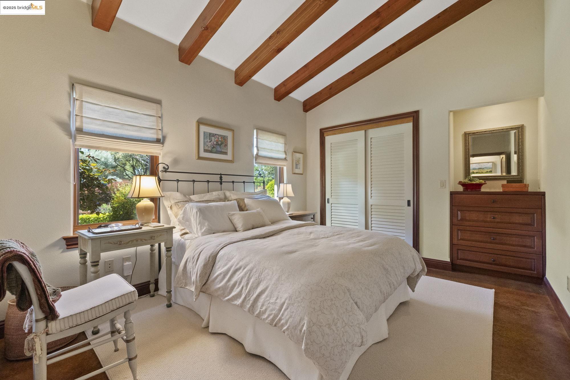 10270 Slate Rim Road Sonora, CA 95370 - Photo 44 of 55 a bedroom with a bed and wooden floor