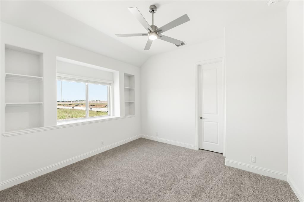 1145 Hitching Post Way Oak Point, TX 75068 - Photo 13 of 39 an empty room with a window and a ceiling fan