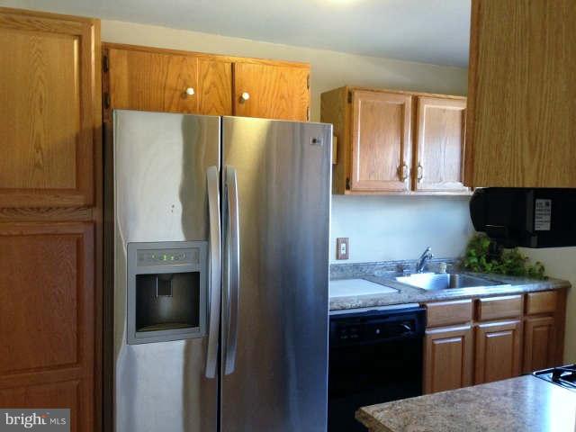 1011 Bayner Road Baltimore, MD 21221 - Photo 12 of 30 a kitchen with a refrigerator sink and stove