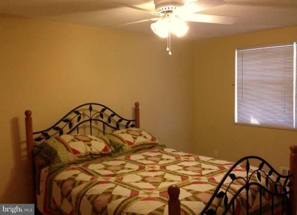 1011 Bayner Road Baltimore, MD 21221 - Photo 14 of 30 a bedroom with a bed and a chandelier